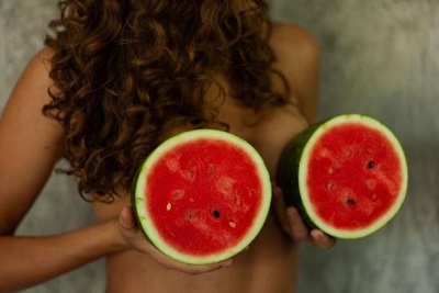 girl holding watermelons over her tits 