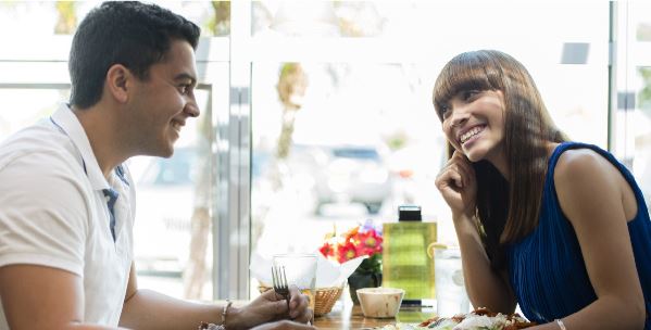 lady and man smiling at each other over lunch 